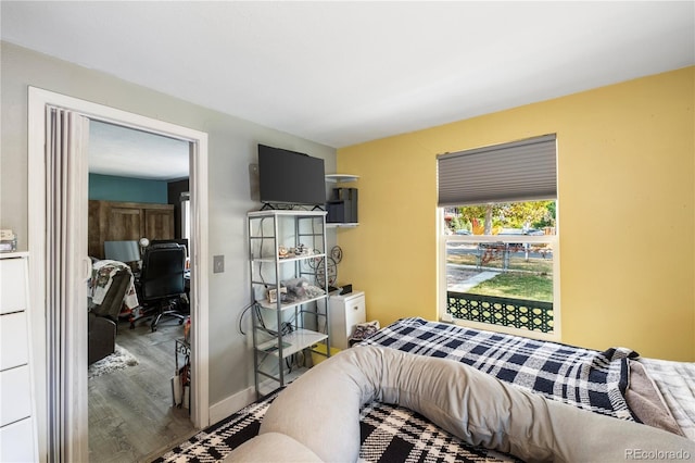 bedroom featuring baseboards and wood finished floors