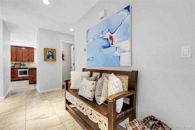 hallway featuring baseboards and recessed lighting