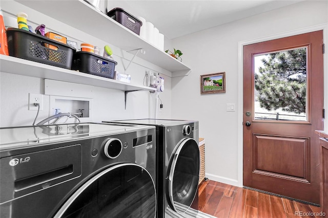 laundry room with baseboards, laundry area, washing machine and dryer, and dark wood-type flooring