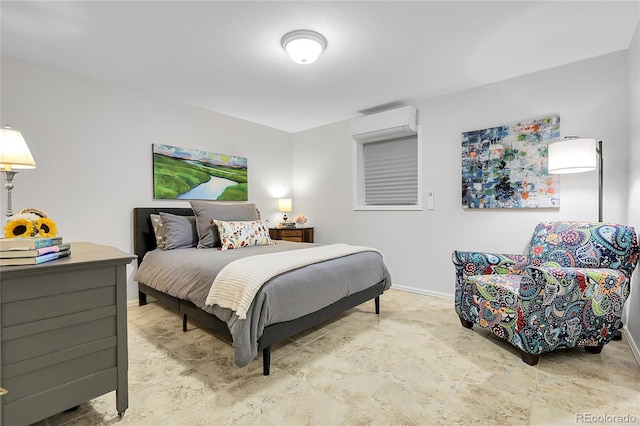 bedroom with a wall mounted AC and baseboards