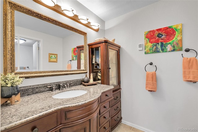 bathroom featuring baseboards, vanity, and tile patterned flooring