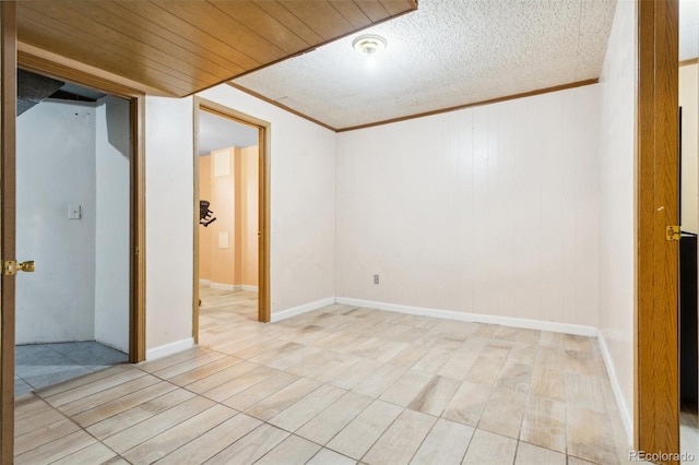 unfurnished room with wood ceiling and ornamental molding