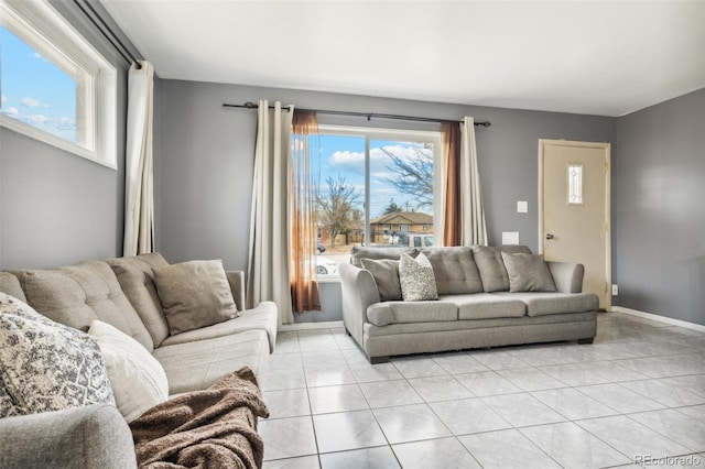 living room featuring plenty of natural light and light tile patterned flooring