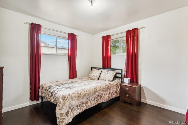 bedroom with dark wood-type flooring