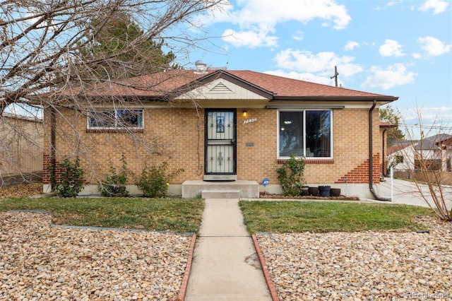 bungalow-style home with a front yard