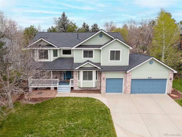 view of front of house with covered porch, driveway, a front yard, roof with shingles, and brick siding