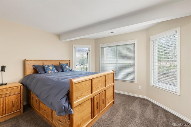bedroom with baseboards, visible vents, and dark carpet