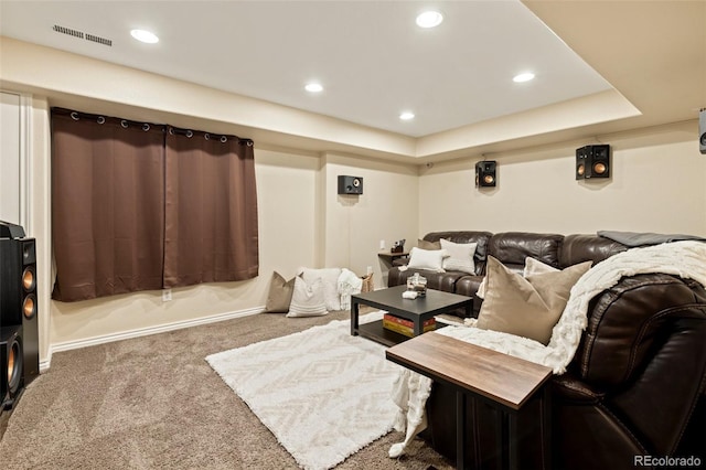 carpeted cinema room featuring visible vents, recessed lighting, baseboards, and a tray ceiling