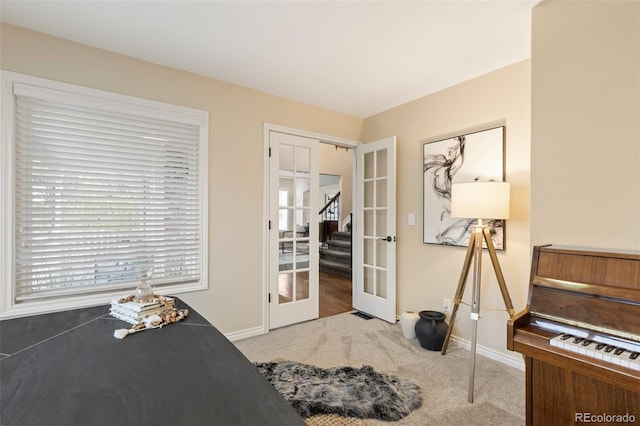 bedroom with french doors, baseboards, and carpet floors