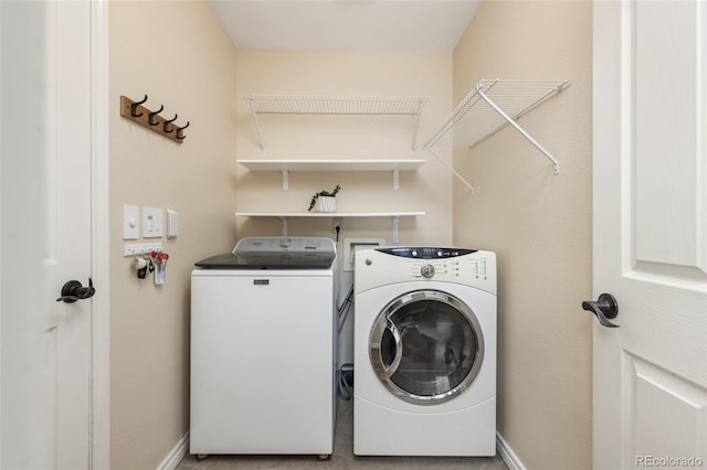laundry room with independent washer and dryer, laundry area, and baseboards