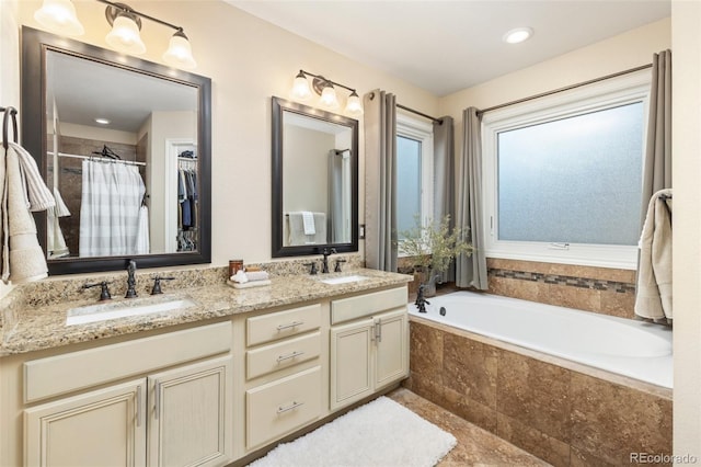 full bathroom featuring a sink, curtained shower, a garden tub, and double vanity