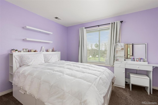 carpeted bedroom featuring visible vents and baseboards