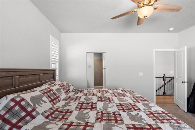 unfurnished bedroom featuring carpet flooring, ceiling fan, and a textured ceiling