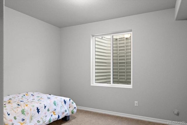 carpeted bedroom with baseboards