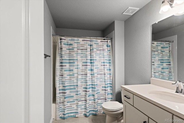 bathroom featuring visible vents, a textured wall, toilet, shower / bath combo, and vanity