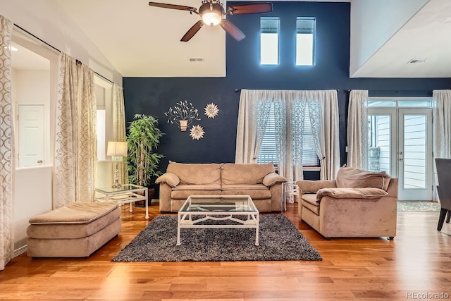 living room featuring ceiling fan, high vaulted ceiling, light hardwood / wood-style floors, and french doors