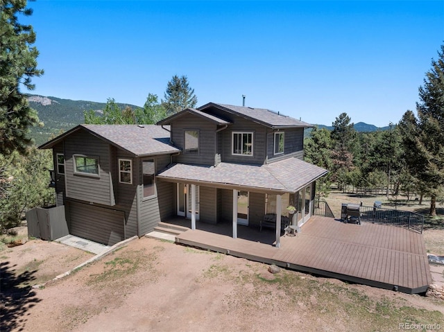 view of front of house featuring a deck with mountain view