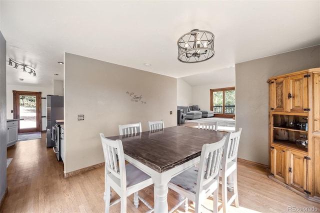 dining room with a notable chandelier and light hardwood / wood-style floors