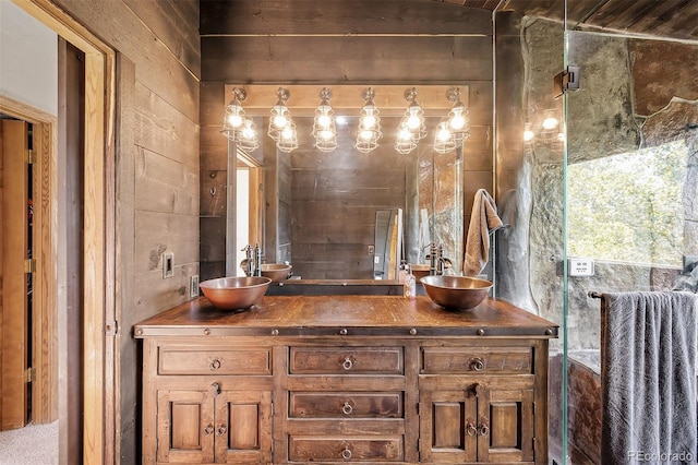 bathroom featuring vanity and wood walls