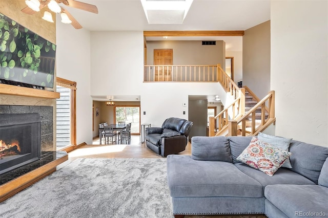 living room with ceiling fan and wood-type flooring