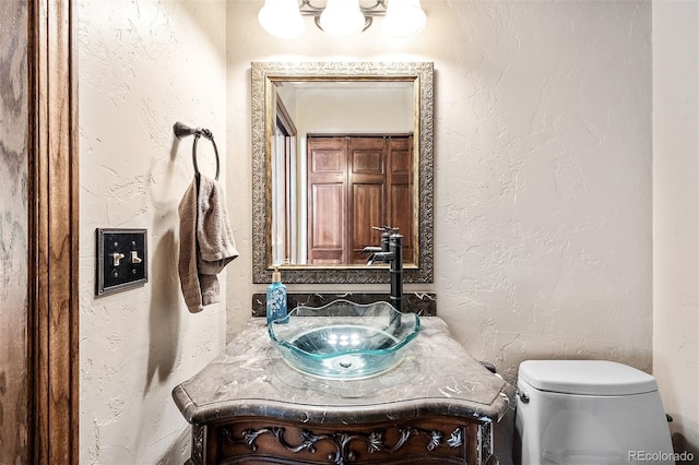 bathroom with vanity and toilet