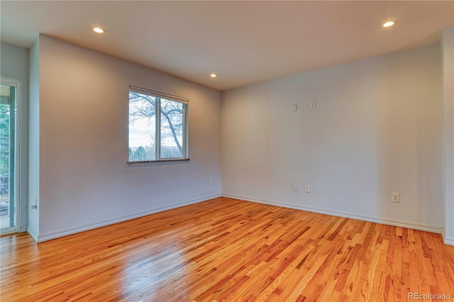 unfurnished room featuring baseboards, light wood-style flooring, and recessed lighting