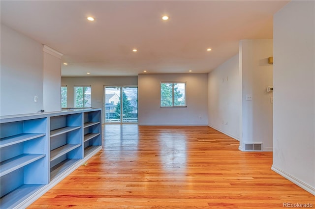 unfurnished room with baseboards, recessed lighting, visible vents, and light wood-style floors