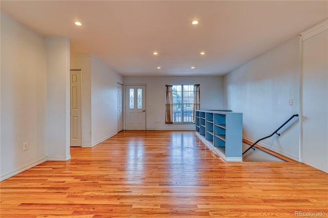 empty room featuring light wood-style floors, baseboards, and recessed lighting