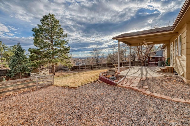 view of yard featuring central air condition unit, a patio area, a fenced backyard, and a ceiling fan