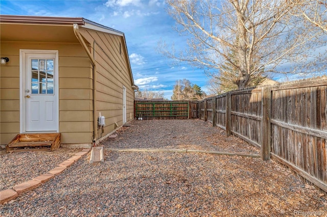 view of yard with entry steps and a fenced backyard