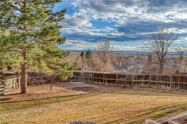 view of yard with a fenced backyard and a mountain view