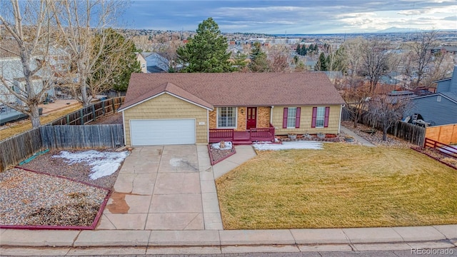 ranch-style house with fence private yard, a front lawn, and concrete driveway