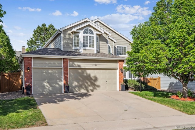 15597 E Dorado Ave, Centennial, CO 80015 - view of front facade featuring brick siding, concrete driveway, and an attached garage