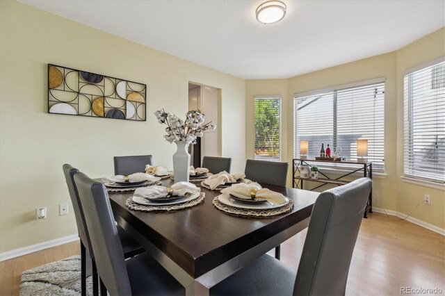 15597 E Dorado Ave, Centennial, CO 80015 - dining space with light wood-style flooring, healthy amount of natural light, and baseboards