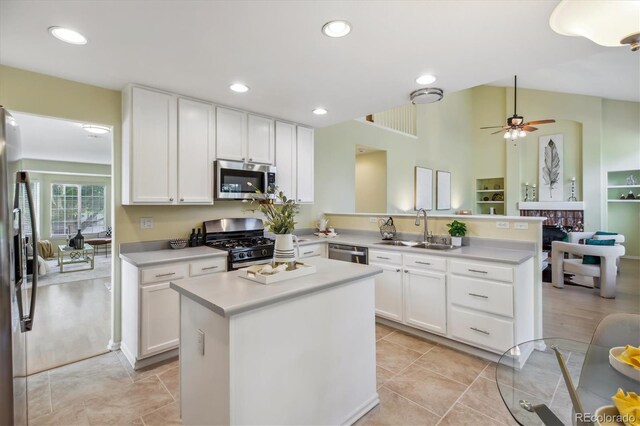 15597 E Dorado Ave, Centennial, CO 80015 - kitchen with stainless steel appliances, a sink, a peninsula, white cabinetry, and recessed lighting