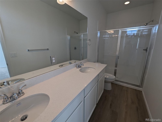 bathroom with hardwood / wood-style floors, toilet, and walk in shower