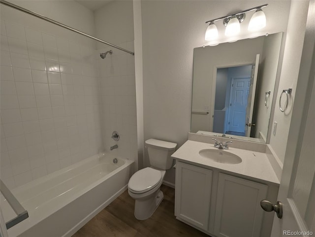 full bathroom with bathtub / shower combination, vanity, hardwood / wood-style flooring, and toilet