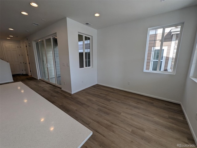 empty room with dark hardwood / wood-style flooring