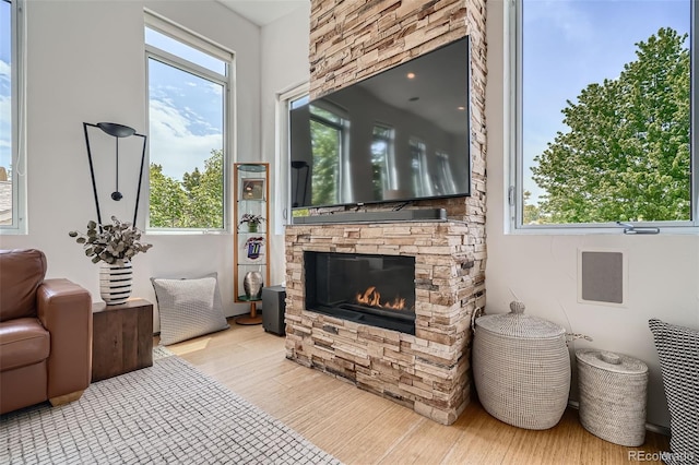 3850 Vallejo St, Denver, CO 80211 - living room featuring a stone fireplace, wood finished floors, and healthy amount of natural light