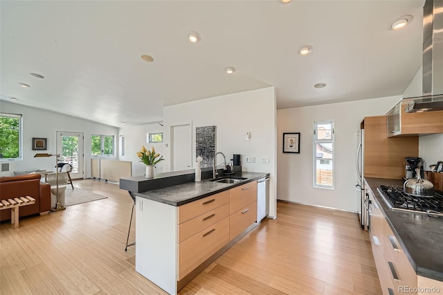 3850 Vallejo St, Denver, CO 80211 - kitchen featuring appliances with stainless steel finishes, dark countertops, a breakfast bar area, light wood-style floors, and recessed lighting