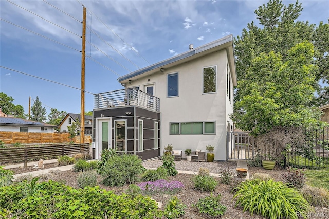 3850 Vallejo St, Denver, CO 80211 - rear view of house featuring a balcony, stucco siding, an outdoor hangout area, and a patio