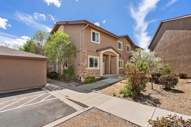 1510 York Rd Unit 100, Colorado Springs, CO 80918 - view of front facade with stucco siding, stone siding, and uncovered parking