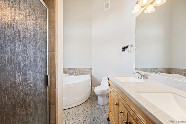 1510 York Rd Unit 100, Colorado Springs, CO 80918 - bathroom featuring a stall shower, a garden tub, speckle patterned floor, double vanity, and toilet