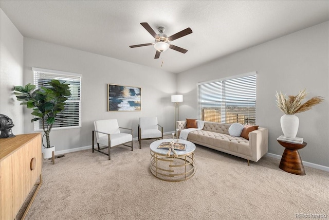 living area featuring light carpet, ceiling fan, and plenty of natural light