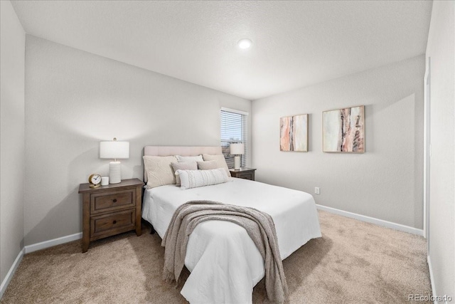 bedroom with light carpet and baseboards