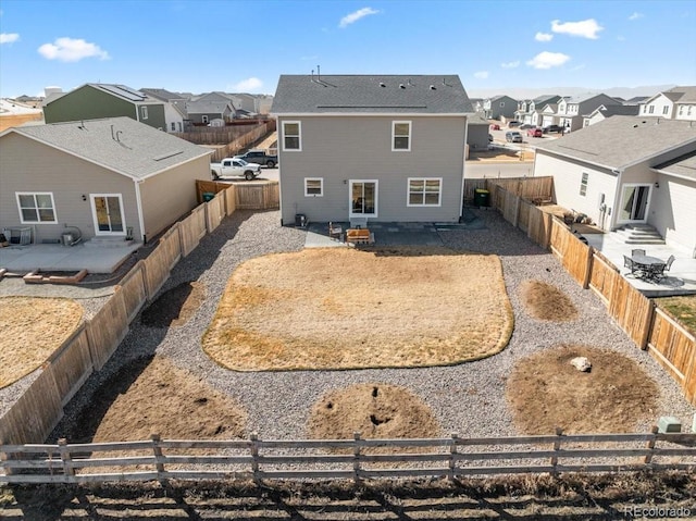 rear view of house with a patio area, a fenced backyard, and a residential view