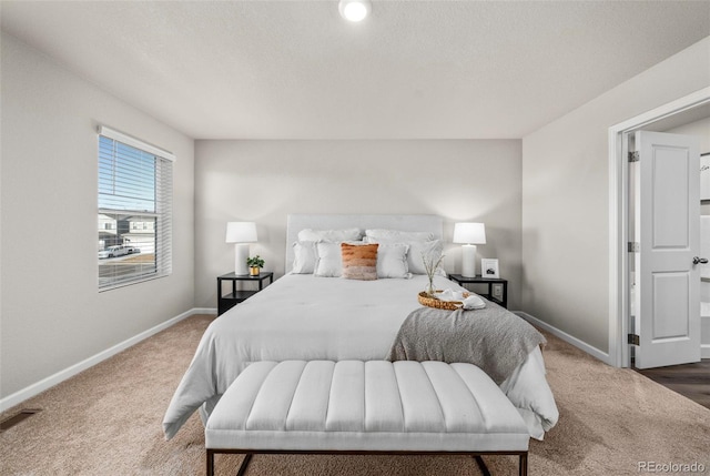 carpeted bedroom featuring visible vents, a textured ceiling, and baseboards