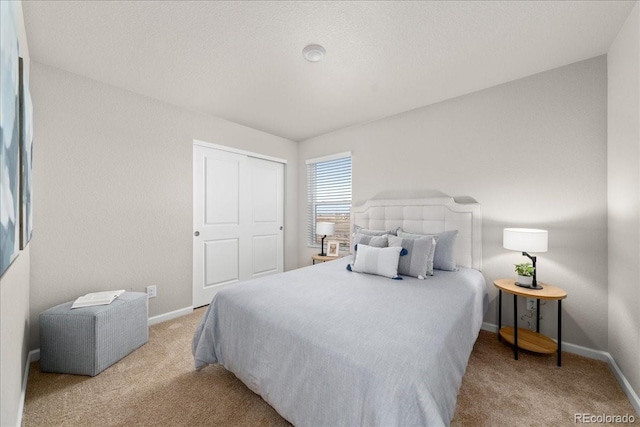 bedroom with carpet floors, a closet, and baseboards