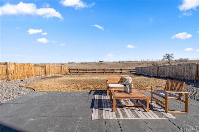 view of patio / terrace with a fenced backyard and a rural view