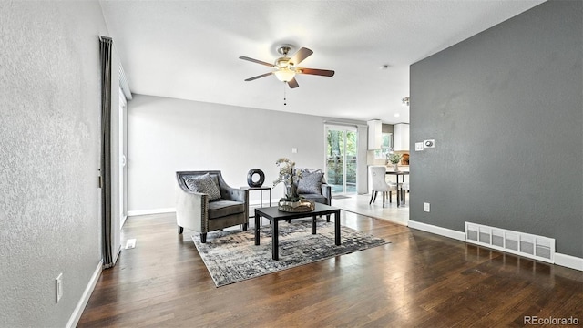 2829 Illinois Ave, Colorado Springs, CO 80907 - living area with a textured wall, ceiling fan, and wood finished floors